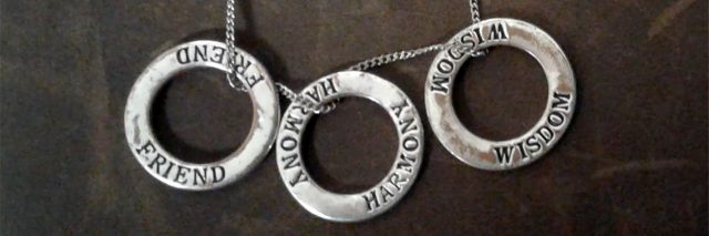 necklace with three rings saying friend harmony wisdom