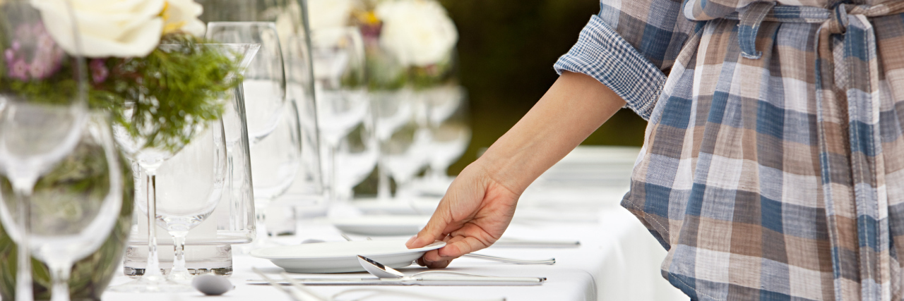 5 Things You Shouldn't Say to People With Gastroparesis A woman setting a table with plates.