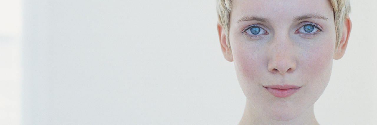 How I Made Fundamental Changes in My Lifestyle to Face PCOS A woman looking into the camera with a serious expression.