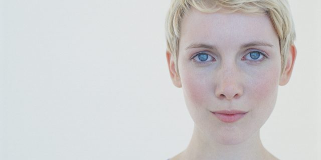 How I Made Fundamental Changes in My Lifestyle to Face PCOS A woman looking into the camera with a serious expression.