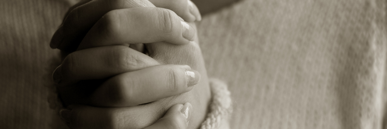 Ways We Can Make Churches Safe for People With Mental Health Struggles Praying woman hands AA monochrome