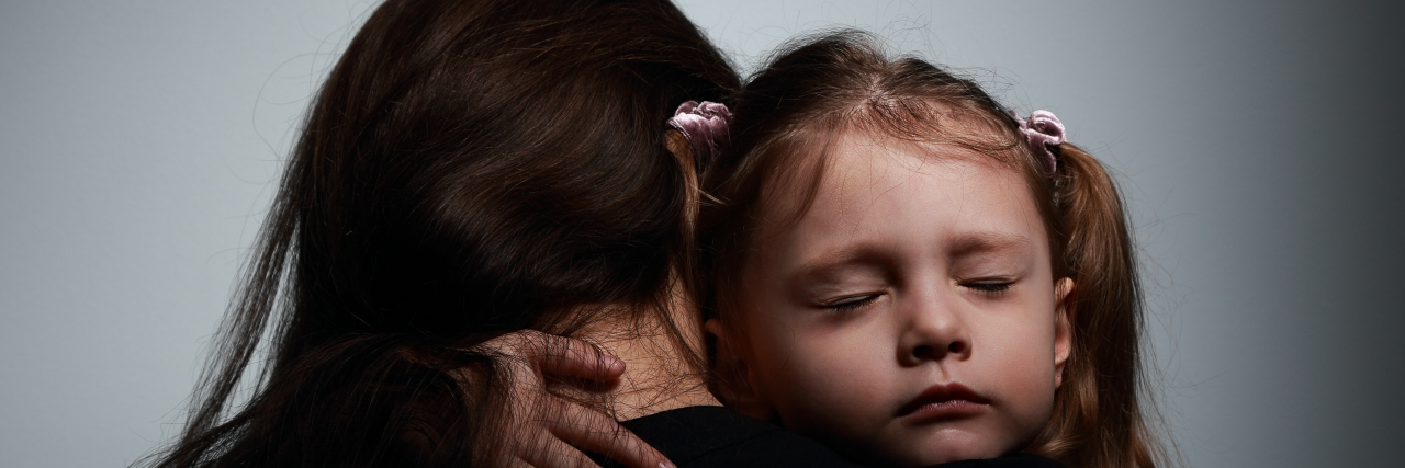 To the Suicidal Mama Fighting to Stay Alive for Her Kids Sad crying daughter hugging her mother with sad face on dark shadows background