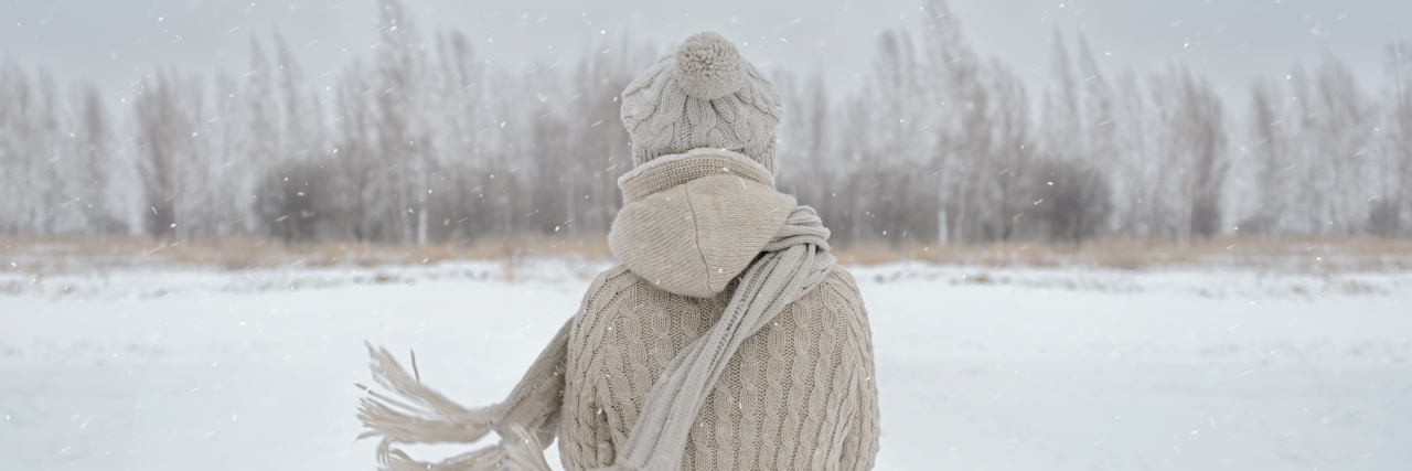 4 Ways to Cope With Depression and Grief During the Holidays Unrecognizable woman stands back in the woods in winter