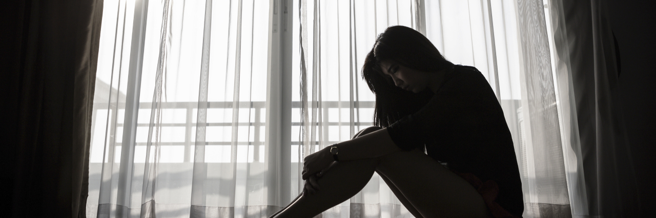 What Victory Over My Body Dysmorphia Looks Like sad woman sitting alone