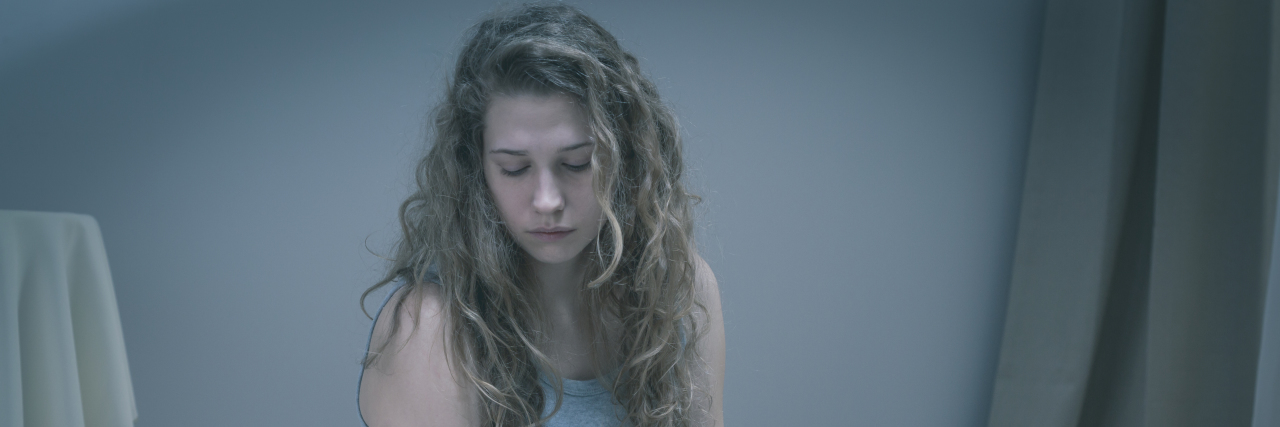 When Depression Makes Showering the Hardest Thing to Do Girl with serious depression sitting in bed