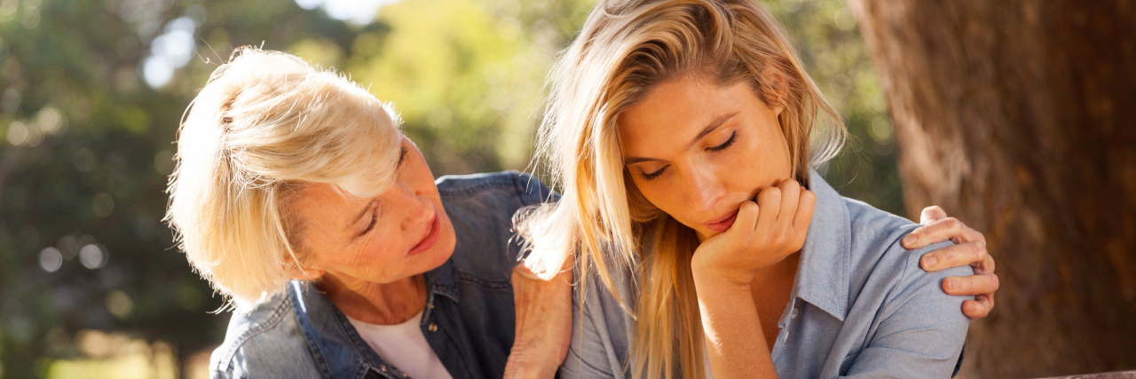 An older woman comforting a younger, upset woman.