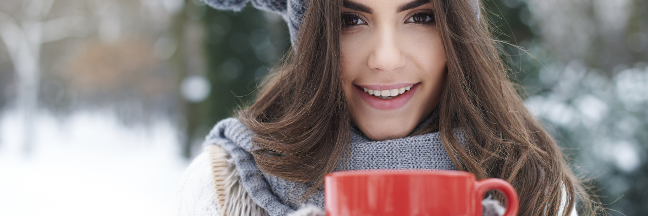 5 Ways I Maintain My Self-Care Routine During the Holidays Warming up of gorgeous young woman in winter