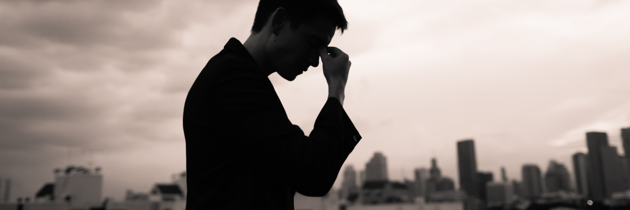 How Distraction Can Help You With Depression and Anxiety stressed upset man in city against cloudy sky