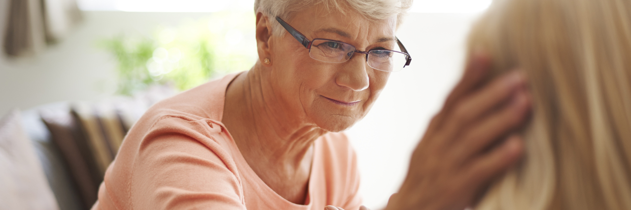 How Parents Can Support a Child After Traumatic Brain Injury Older mother comforting adult daughter.