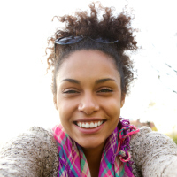 A woman taking a selfie, smiling.
