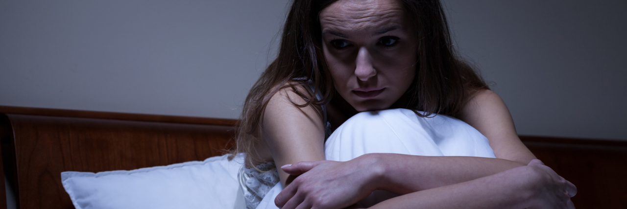 What I Do When I Realize It's Going to Be a Hard Night Young worried woman sitting in bed at night