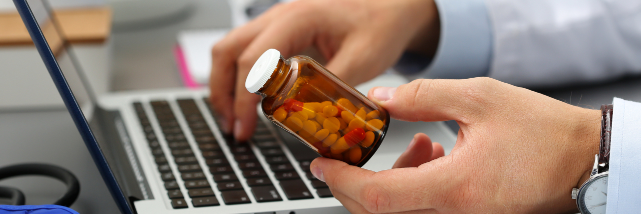 Not Being Able to Refill Prescription Due to Interpretation of Laws pharmacist holding prescription bottle