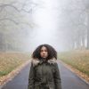 African-American girl walking alone in autumn.