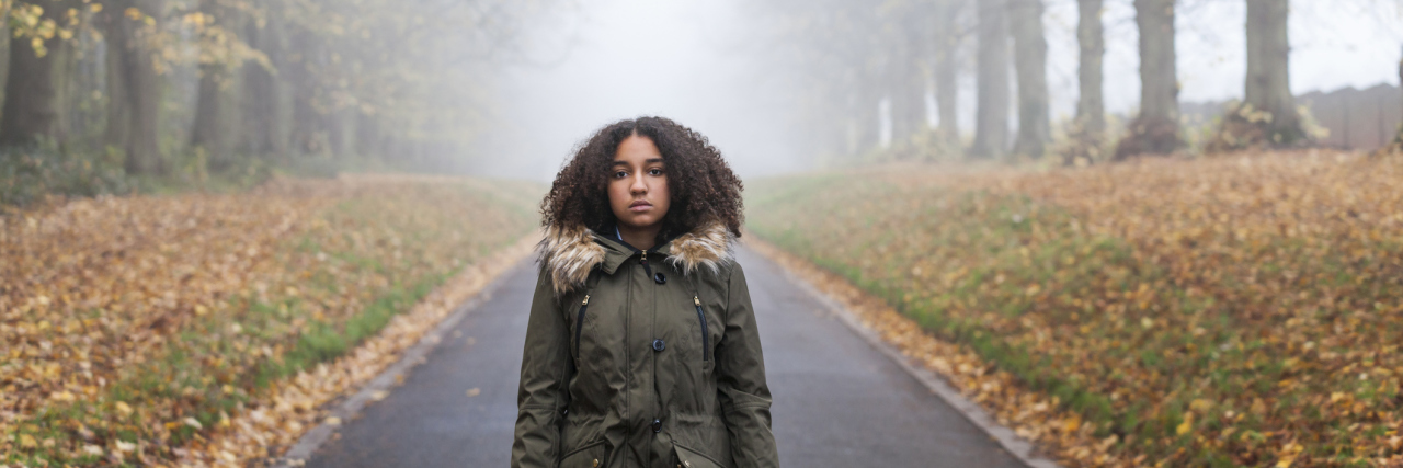 Minority Patients and Undiagnosed Autism African-American girl walking alone in autumn.