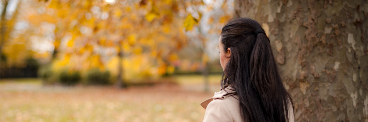 How Grief Has Changed My Personality and Everyday Life Woman standing next to tree in park during autumn