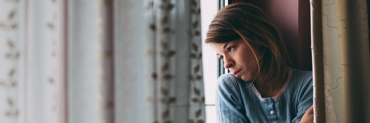 When Anxiety and Depression Make You Jealous of Other Women Young sad woman sitting on the window looking outside
