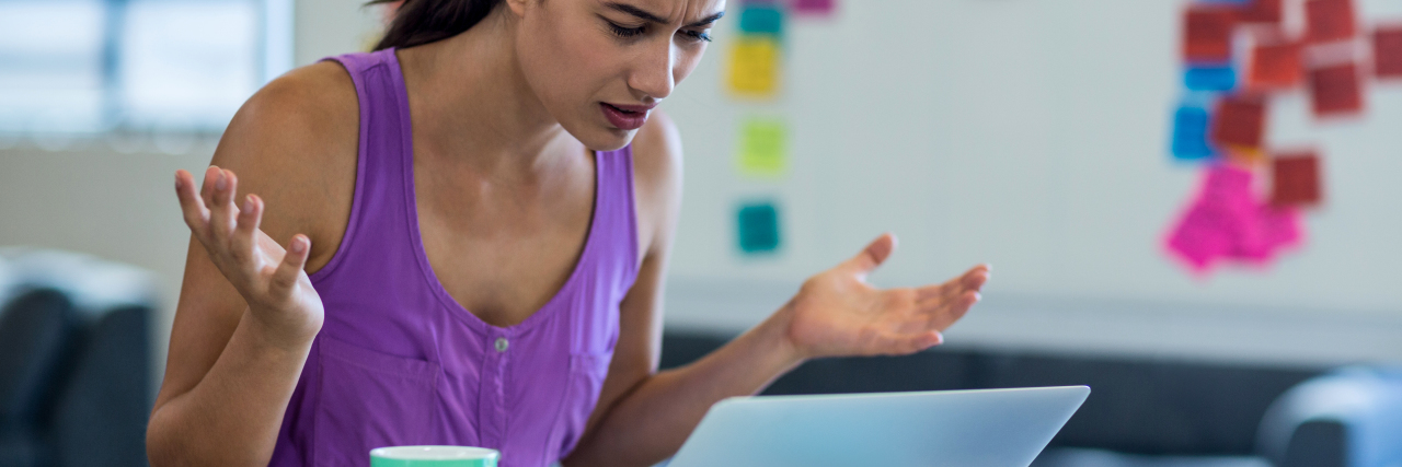 Why Pinterest 'Inspiration' Needs a Mental Health Makeover Young woman looking surprised while using the laptop in the office