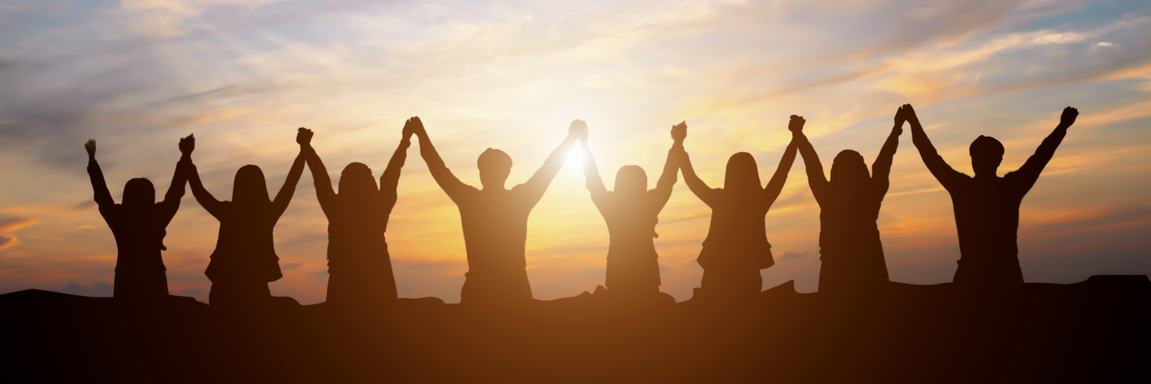 Sharing Our Victories as Members of the Stomach Cancer Community Silhouette of happy business team making high hands in sunset sky background for business teamwork concept