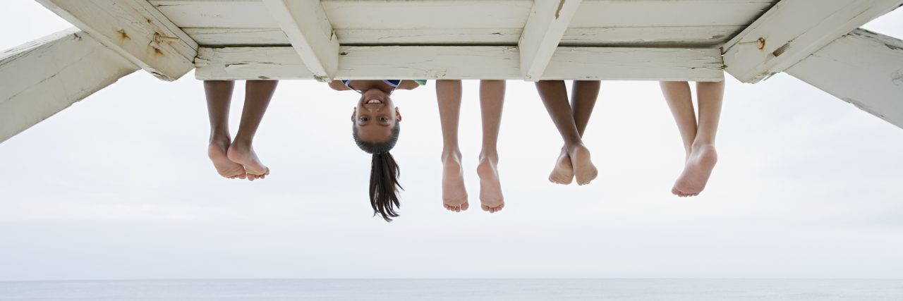 Girl upside down on a dock