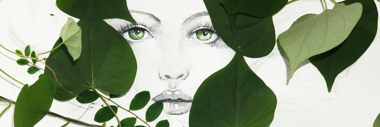 Drawn watercolor of woman face decorated with real green leaves. Perfect image as birthday card.