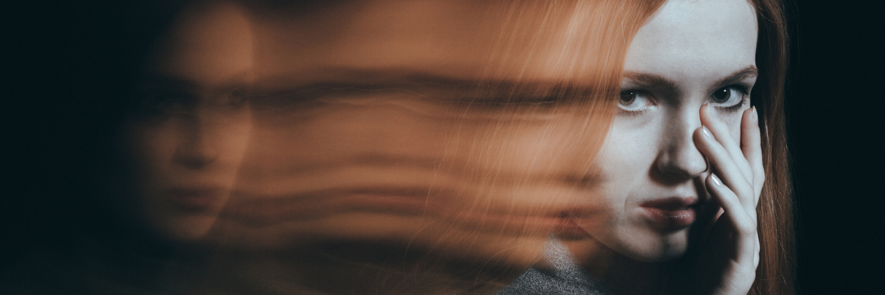 Woman looking at camera crying blurred face distorted multiple exposure