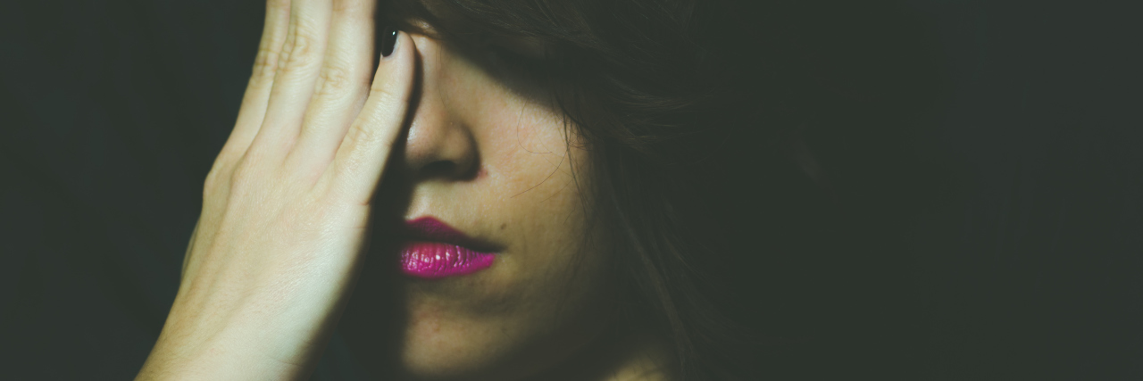 Dear Self, Read This When You're Feeling Suicidal Young depressed woman feeling miserable and lonely cover her face with her hands in the dark room of her home