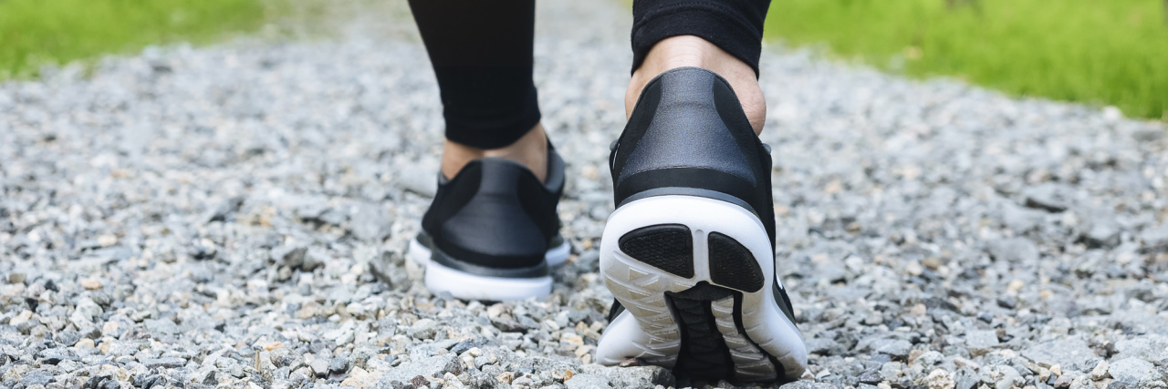 Getting AFOs With Charcot-Marie-Tooth Disease Woman walking along trail.