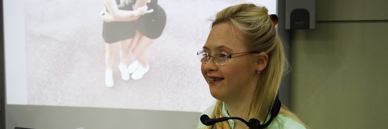 My Daughter With Down Syndrome Is Making a Difference Grace, woman with Down syndrome, giving speech at a school