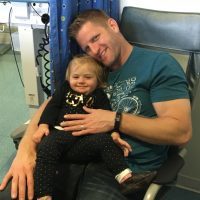 Father holding little girl at hospital