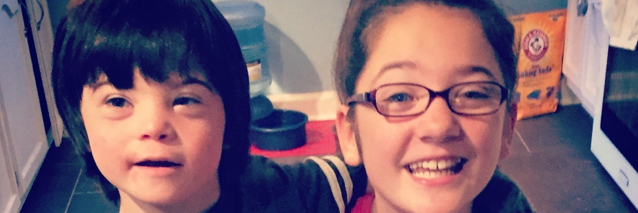 Don't Be Sorry My Child Has Down Syndrome Brother and sister hugging. Boy has Down syndrome.