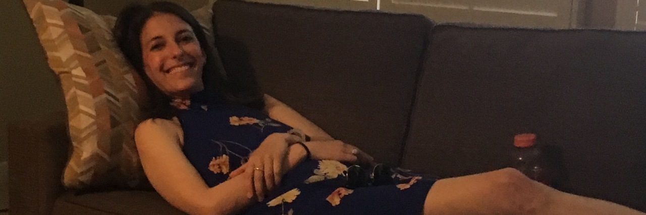 When Taking Care of Yourself Is a Full-Time Job The writer of the article laying on a couch.