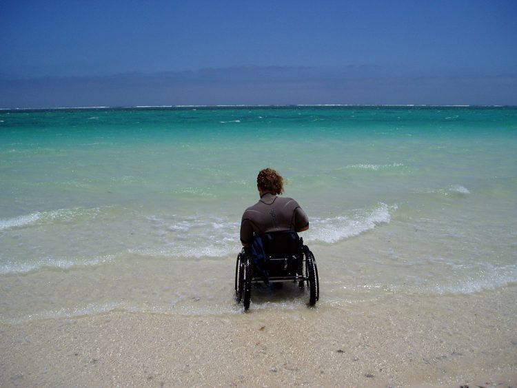 Kev in his wheelchair at the beach.