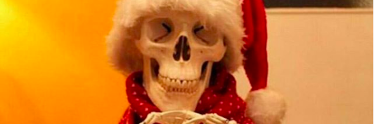 15 Memes About Living With a Chronic Illness During the Holidays skeleton wearing santa hat and scarf