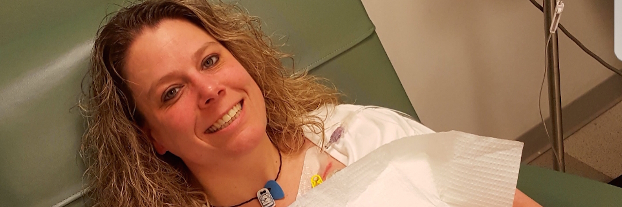 The writer in a hospital chair, with her computer on her lap.