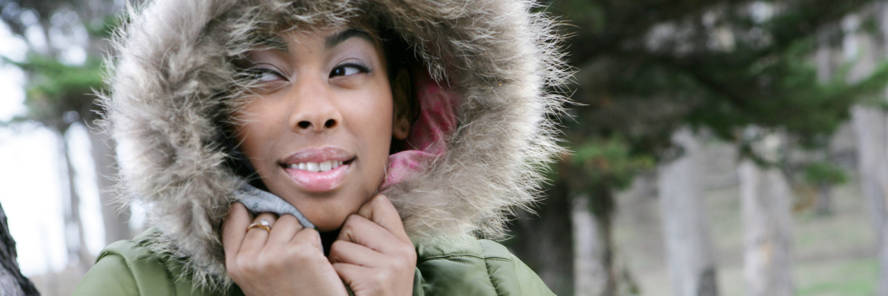 Portrait of young African American woman in fur hooded coat.