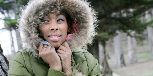 Portrait of young African American woman in fur hooded coat.