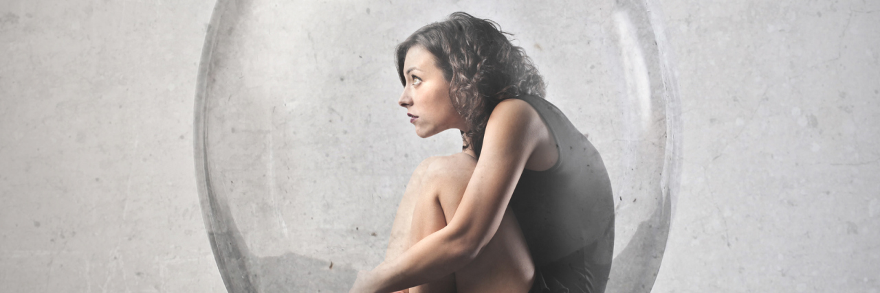 Fearing Flare-Ups With Chronic Illness woman trapped inside a glass jar