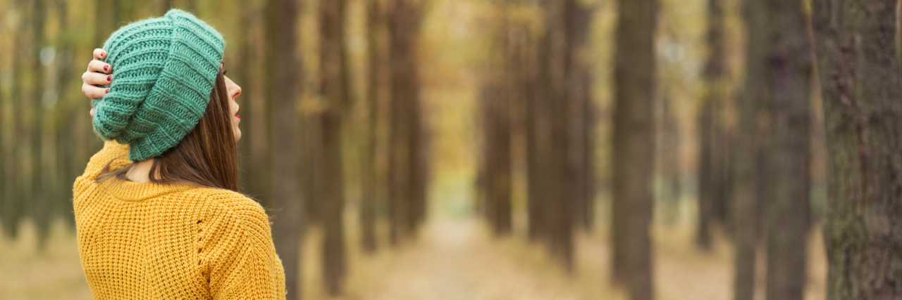 Why Being Sick Made Me Believe I Wasn't Worthy of Love Lonely girl walking in the autumn park