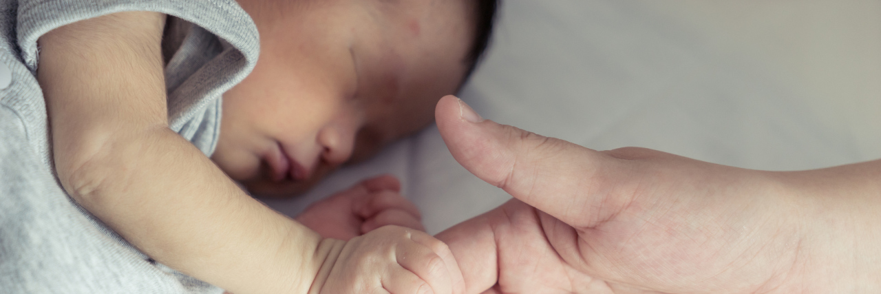 My Down Syndrome Birth Story Mother holds her newborn baby.