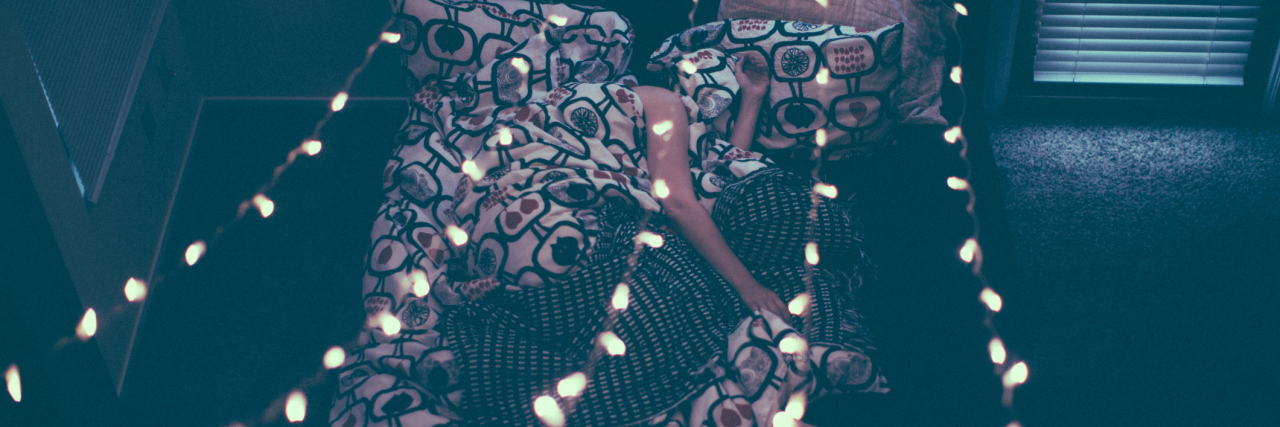 Why I Remain Hopeful When My Health Is Uncertain A photo of a woman in bed, tired.