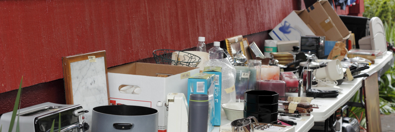Giving Up Possessions I No Longer Use Due to Chronic Pain items on a table at a yard sale