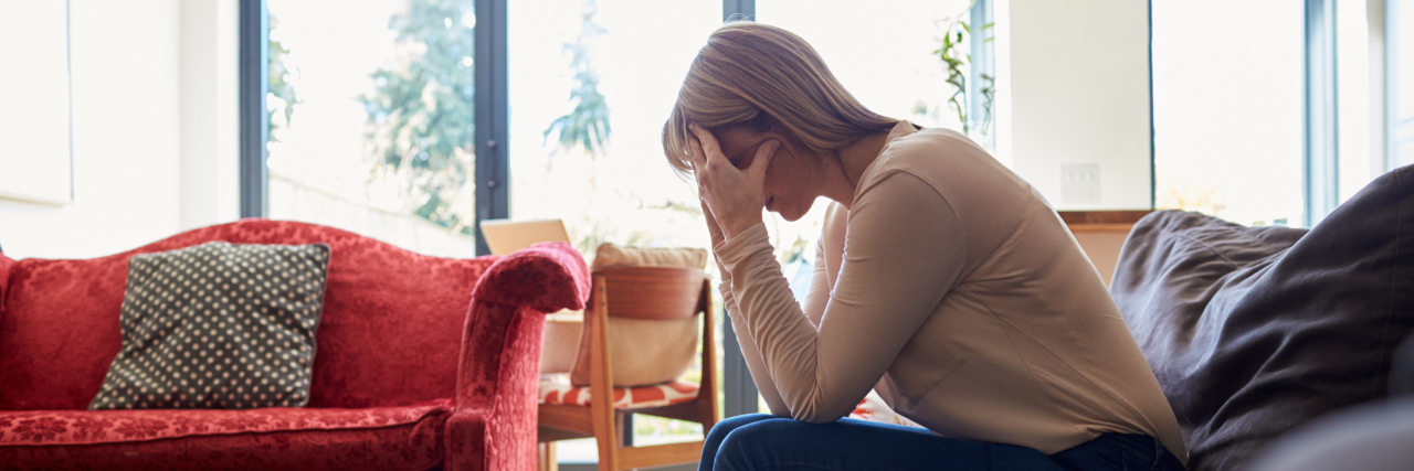 The Most Frustrating Parts of Being Chronically Ill woman sitting on her couch looking frustrated