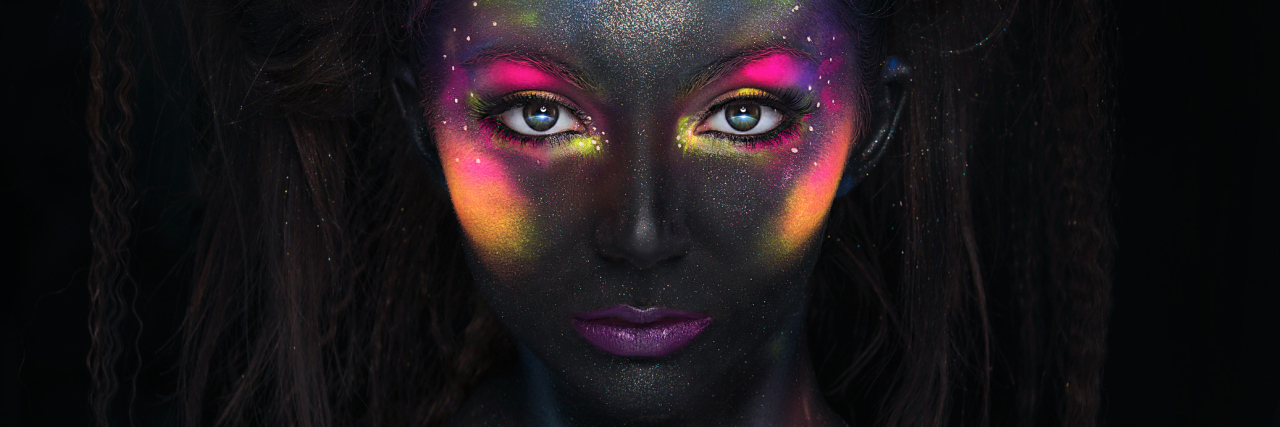 Glowing neon makeup with dramatic look.