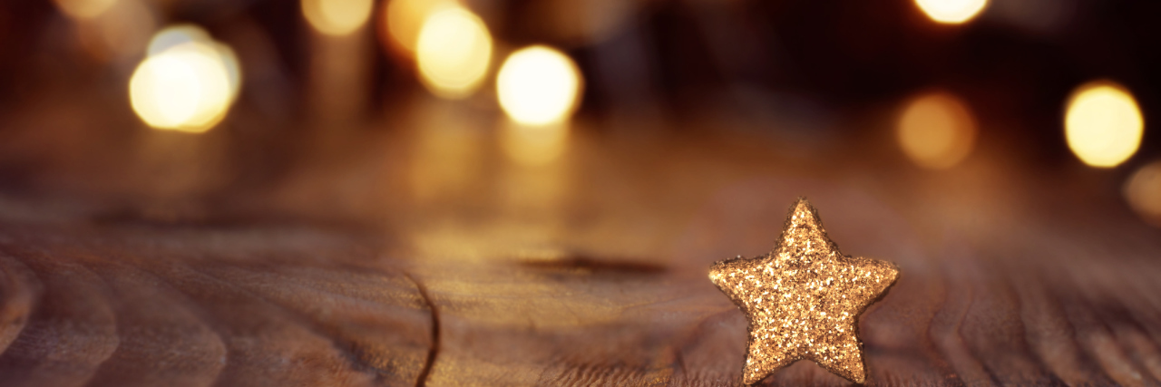 Holiday Gift Suggestions for People Diagnosed With Cancer Christmas background with stars and bokeh
