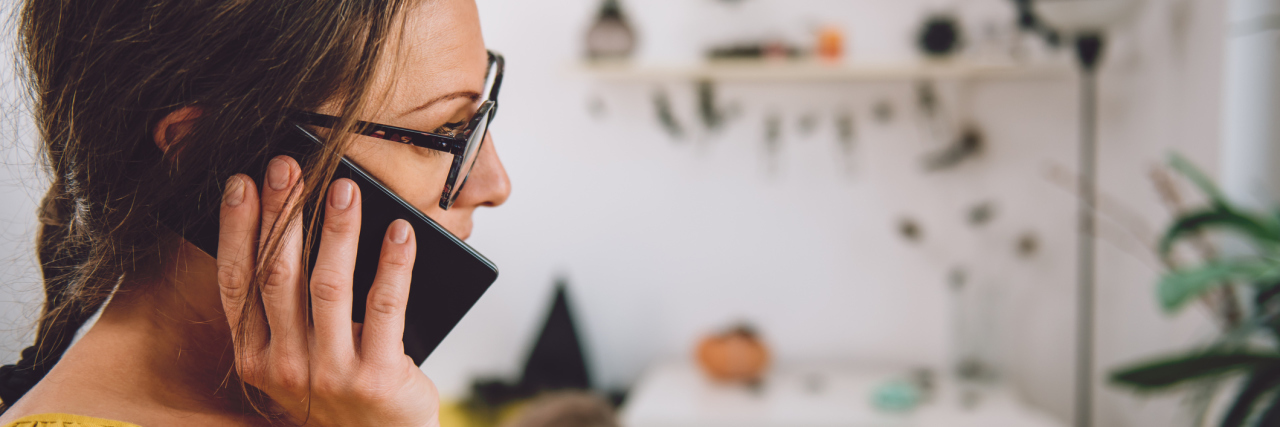 Chronic Back Pain: Explaining Why It Takes a While to Recover woman talking on the phone at home