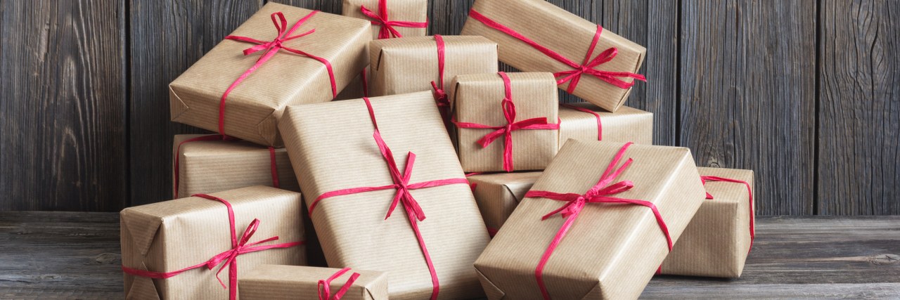 10 Gifts to Give a Friend With Depression Vintage packages against the background of the old wooden boards