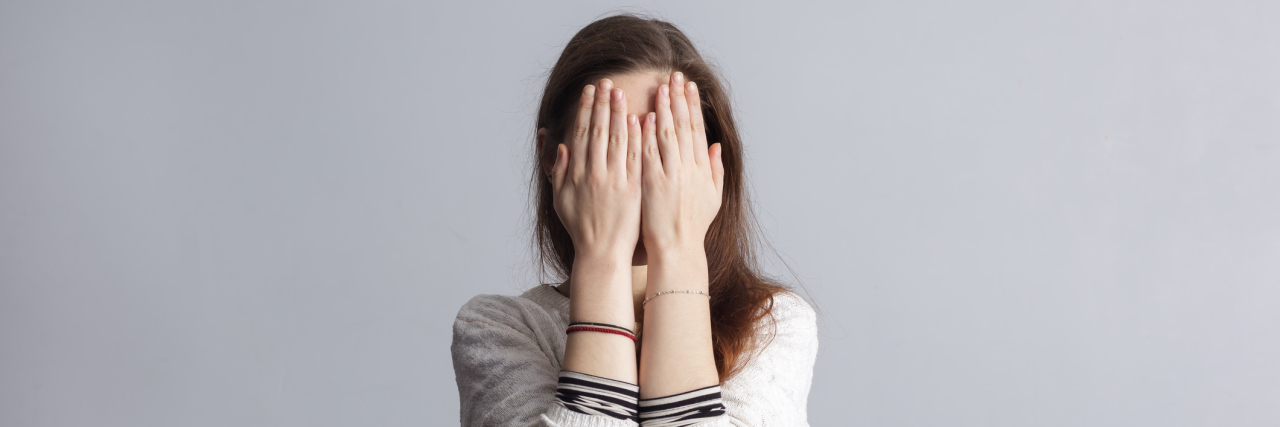 The Aspects of Ehlers-Danlos Syndrome I Hide Every Day woman covering her face with her hands