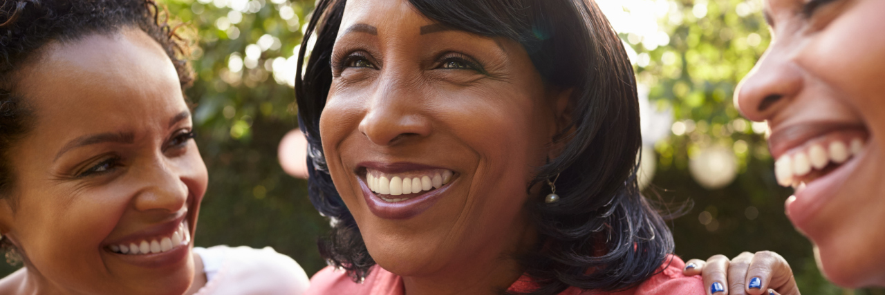 9 Ways to Better Support Someone With a Chronic Illness Three African American women standing together outside.