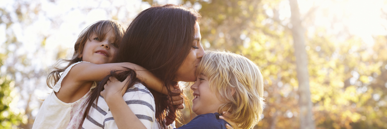 How I Balance Motherhood and Multiple Sclerosis mom playing with her two kids outside