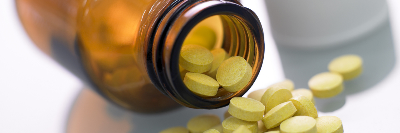 ADHD With and Without Medication Pills spilling from bottle.